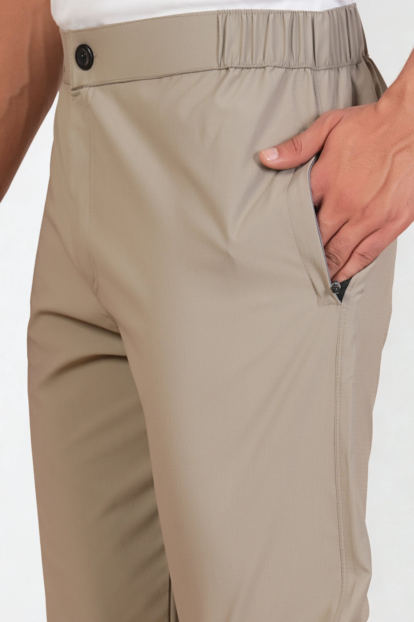 Beige pants with a white background