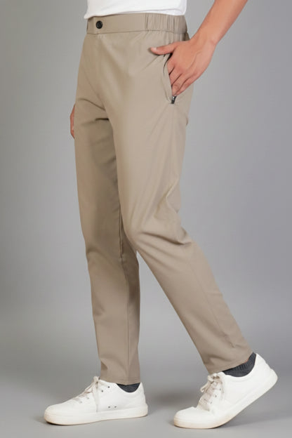 Beige pants worn by a person on a gray background