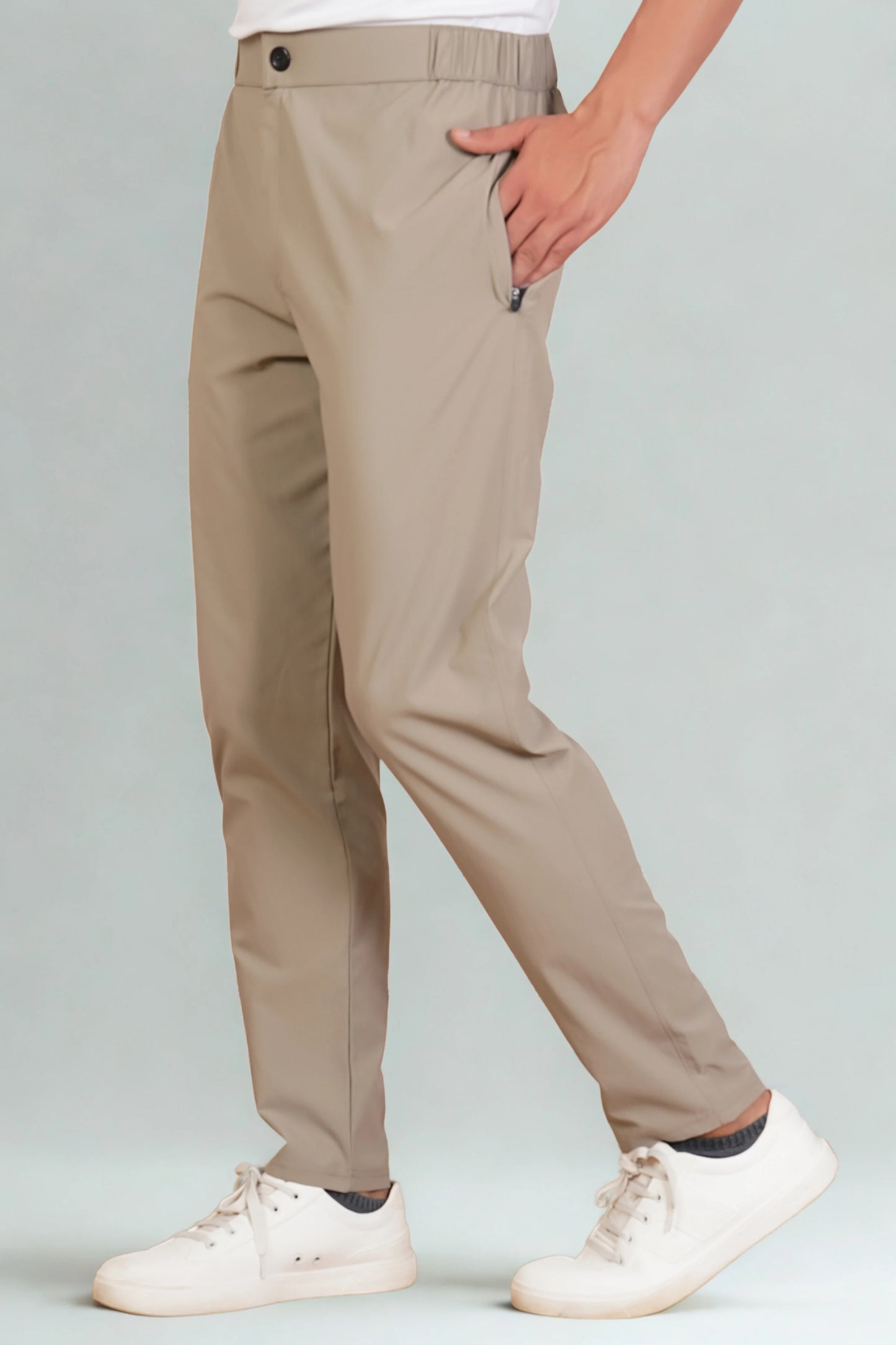 Beige pants worn by a person on a light gray background