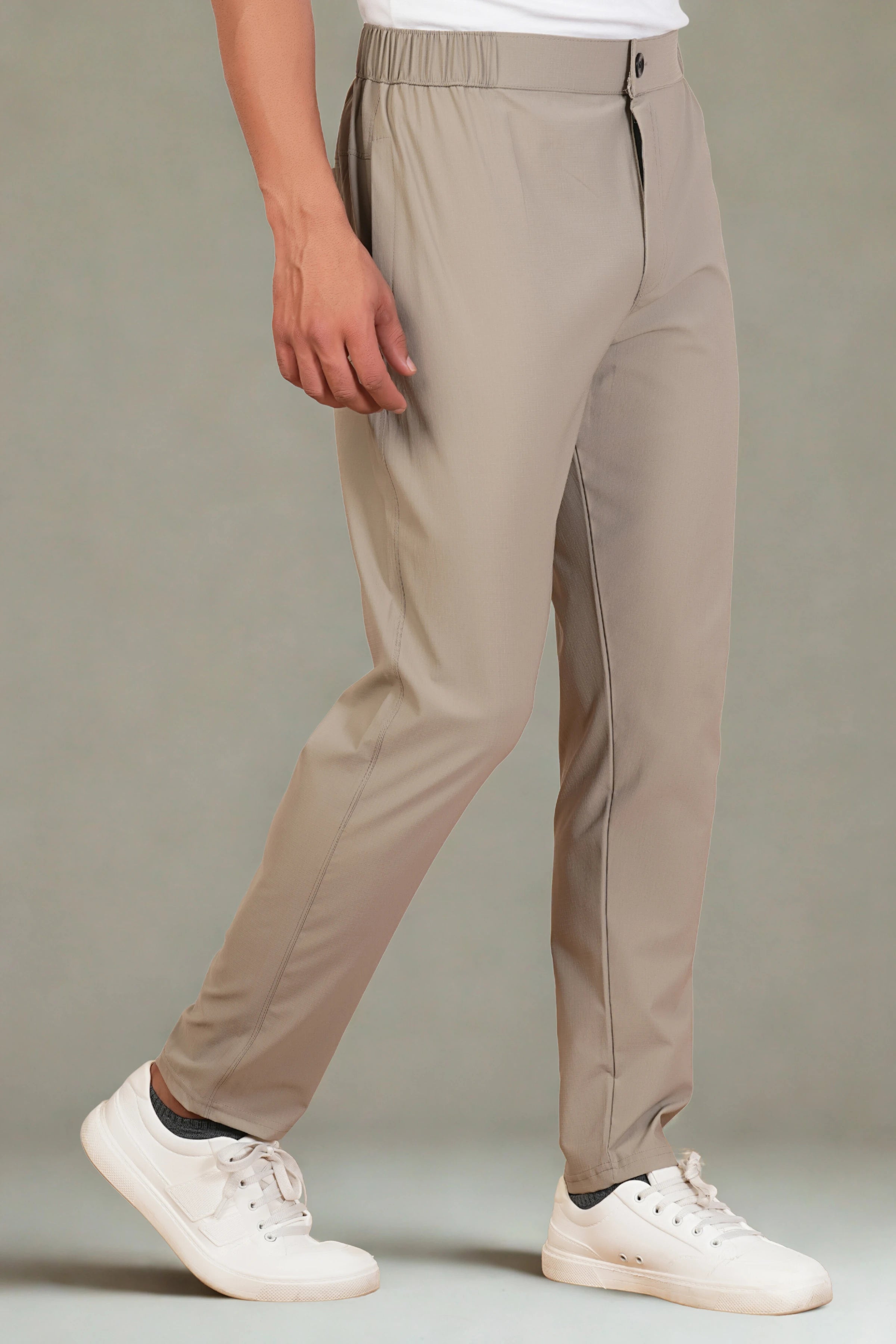 Beige pants worn by a person on a plain background