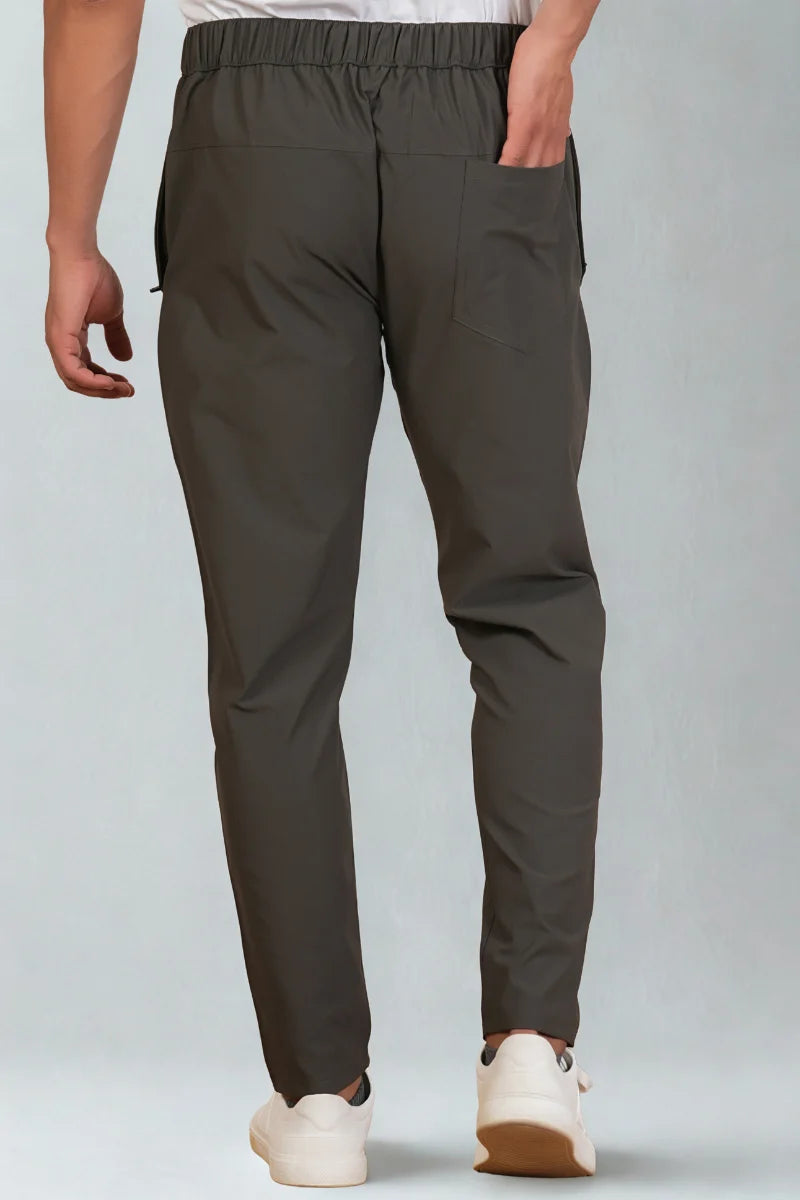 Person wearing dark gray pants on a light gray background