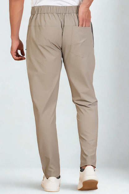 Beige pants worn by a person on a white background